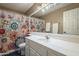 Bathroom features a single sink vanity, decorative shower curtain and tub, and ample lighting at 6433 W Beverly Ln, Glendale, AZ 85306