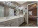 Bathroom features a double sink vanity, tile floors, and ample lighting at 6433 W Beverly Ln, Glendale, AZ 85306