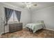 Bedroom offers a dresser, a ceiling fan, and decorative tile floors at 6433 W Beverly Ln, Glendale, AZ 85306