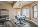 Dining area featuring a modern glass table set and a large window for ample light at 6433 W Beverly Ln, Glendale, AZ 85306