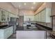 Open kitchen with stainless steel appliances, black countertops and ample cabinet space at 6433 W Beverly Ln, Glendale, AZ 85306