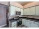 Close up of the kitchen with stainless steel oven, microwave and black countertops at 6433 W Beverly Ln, Glendale, AZ 85306