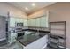 Updated kitchen with stainless steel appliances and sleek black countertops at 6433 W Beverly Ln, Glendale, AZ 85306