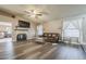 Spacious living room featuring wood floors, a fireplace, and a large leather couch at 6433 W Beverly Ln, Glendale, AZ 85306