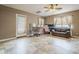 Open living area features a ceiling fan, neutral paint, tile flooring, and natural light at 6433 W Beverly Ln, Glendale, AZ 85306