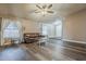 Cozy living room with wood floors, large windows, and a comfortable leather couch at 6433 W Beverly Ln, Glendale, AZ 85306