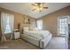 Spacious bedroom with a king bed, neutral paint, a ceiling fan, and carpet flooring at 6433 W Beverly Ln, Glendale, AZ 85306