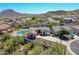 Aerial view of a home featuring a private pool, spa, and lush landscaping in a desert community at 6603 W Via Dona Rd, Phoenix, AZ 85083