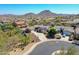 Aerial view of a residential neighborhood with well-maintained landscaping and mountain views at 6603 W Via Dona Rd, Phoenix, AZ 85083