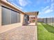 Spacious backyard featuring a covered patio, pavers, artificial turf, and secure fencing at 6603 W Via Dona Rd, Phoenix, AZ 85083