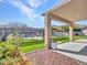 Inviting backyard featuring artificial turf, a pool with rock features, and a covered patio for outdoor relaxation at 6603 W Via Dona Rd, Phoenix, AZ 85083