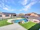 A backyard featuring a pool, rock features, artificial turf, and privacy fencing at 6603 W Via Dona Rd, Phoenix, AZ 85083