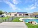 The backyard boasts a pool with rock features, synthetic turf, solar panels, and a privacy fence at 6603 W Via Dona Rd, Phoenix, AZ 85083