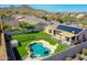 A high-angle shot of a backyard featuring a pool, spa and desert landscape at 6603 W Via Dona Rd, Phoenix, AZ 85083