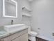 Stylish bathroom with unique vessel sink, floating shelves, and modern fixtures at 6603 W Via Dona Rd, Phoenix, AZ 85083