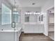 Bright bathroom featuring a soaking tub, shower, double sink vanity, and walk-in closet access at 6603 W Via Dona Rd, Phoenix, AZ 85083