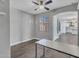 Bedroom with wood-look tile floors, ceiling fan, and large window at 6603 W Via Dona Rd, Phoenix, AZ 85083