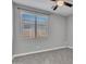 Well-lit bedroom featuring neutral paint, soft carpet, and a ceiling fan at 6603 W Via Dona Rd, Phoenix, AZ 85083