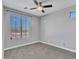 Cozy bedroom with a large window, neutral paint, and a ceiling fan at 6603 W Via Dona Rd, Phoenix, AZ 85083