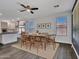 Elegant dining room with modern light fixtures, a ceiling fan, and large windows that offer ample natural light at 6603 W Via Dona Rd, Phoenix, AZ 85083