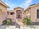 Inviting gated entry with desert plants, decorative lighting, and a charming courtyard with intricate ironwork at 6603 W Via Dona Rd, Phoenix, AZ 85083