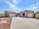 Inviting single-story home with a two-car garage, desert landscaping and a concrete driveway nestled among a desert landscape at 6603 W Via Dona Rd, Phoenix, AZ 85083