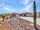 Single-story desert home with a two-car garage, desert landscaping, and paved driveway at 6603 W Via Dona Rd, Phoenix, AZ 85083