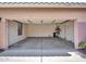 Empty two car garage with concrete flooring at 6603 W Via Dona Rd, Phoenix, AZ 85083