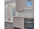 Light, bright hallway features a beverage cooler, grey cabinets and a window overlooking the back yard at 6603 W Via Dona Rd, Phoenix, AZ 85083