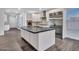 Modern kitchen with stainless steel appliances, island, and sleek cabinetry, perfect for cooking and entertaining at 6603 W Via Dona Rd, Phoenix, AZ 85083