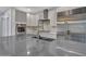 Modern kitchen island with stainless steel appliances and grey countertops, creating a functional cooking space at 6603 W Via Dona Rd, Phoenix, AZ 85083