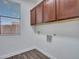 Functional laundry room featuring overhead cabinets and hookups for a washer and dryer at 6603 W Via Dona Rd, Phoenix, AZ 85083