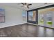 Bright living room with natural light, featuring wood-look tile flooring and a view of the backyard at 6603 W Via Dona Rd, Phoenix, AZ 85083