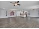 Open floor plan with wood-look tile flowing into a bright kitchen with an island and stainless appliances at 6603 W Via Dona Rd, Phoenix, AZ 85083