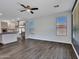 Open-concept living area with tile flooring, a modern kitchen, and abundant natural light at 6603 W Via Dona Rd, Phoenix, AZ 85083