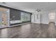 Bright living room with neutral walls, tile flooring, and stylish built-in shelving for storage at 6603 W Via Dona Rd, Phoenix, AZ 85083