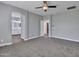 Neutral primary bedroom with soft carpet, ceiling fan, walk-in closet, and an ensuite bathroom at 6603 W Via Dona Rd, Phoenix, AZ 85083