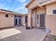 Charming outdoor patio with brick pavers and string lights at 6603 W Via Dona Rd, Phoenix, AZ 85083