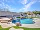 Stunning backyard featuring a custom pool with rock waterfall, hot tub, and basketball hoop at 6603 W Via Dona Rd, Phoenix, AZ 85083