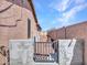 Side yard features a gravel area with a gate, providing access and functionality to the outdoor space at 6603 W Via Dona Rd, Phoenix, AZ 85083