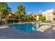 Well-kept community pool surrounded by lounge chairs and mature trees at 7008 E Gold Dust Ave # 236, Scottsdale, AZ 85253