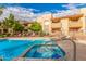 Spacious community pool area with hot tub, deck chairs, and lush trees at 7008 E Gold Dust Ave # 236, Scottsdale, AZ 85253