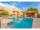 Exterior angle showcasing the beautiful blue community pool and seating area under a tiled pergola at 7008 E Gold Dust Ave # 236, Scottsdale, AZ 85253