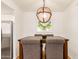 This dining area features a wooden table with upholstered chairs and a modern light fixture at 7008 E Gold Dust Ave # 236, Scottsdale, AZ 85253