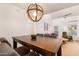 Stylish dining area with a modern light fixture and views into the living room at 7008 E Gold Dust Ave # 236, Scottsdale, AZ 85253