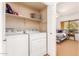 The laundry room includes a washer, dryer and shelving for storage at 7008 E Gold Dust Ave # 236, Scottsdale, AZ 85253