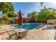 A beautiful pool with tables, chairs, and lounge chairs for relaxing on a sunny day at 7008 E Gold Dust Ave # 236, Scottsdale, AZ 85253