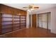 This bedroom features custom built-in shelving and storage, hardwood floors, and standard ceiling fan at 808 W 9Th St, Tempe, AZ 85281