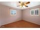 This bedroom features hardwood floors, two windows with blinds, and ceiling fan with decorative lighting at 808 W 9Th St, Tempe, AZ 85281