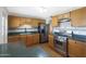 Well-lit kitchen featuring stainless steel appliances and natural wood cabinets, a practical and stylish space at 808 W 9Th St, Tempe, AZ 85281